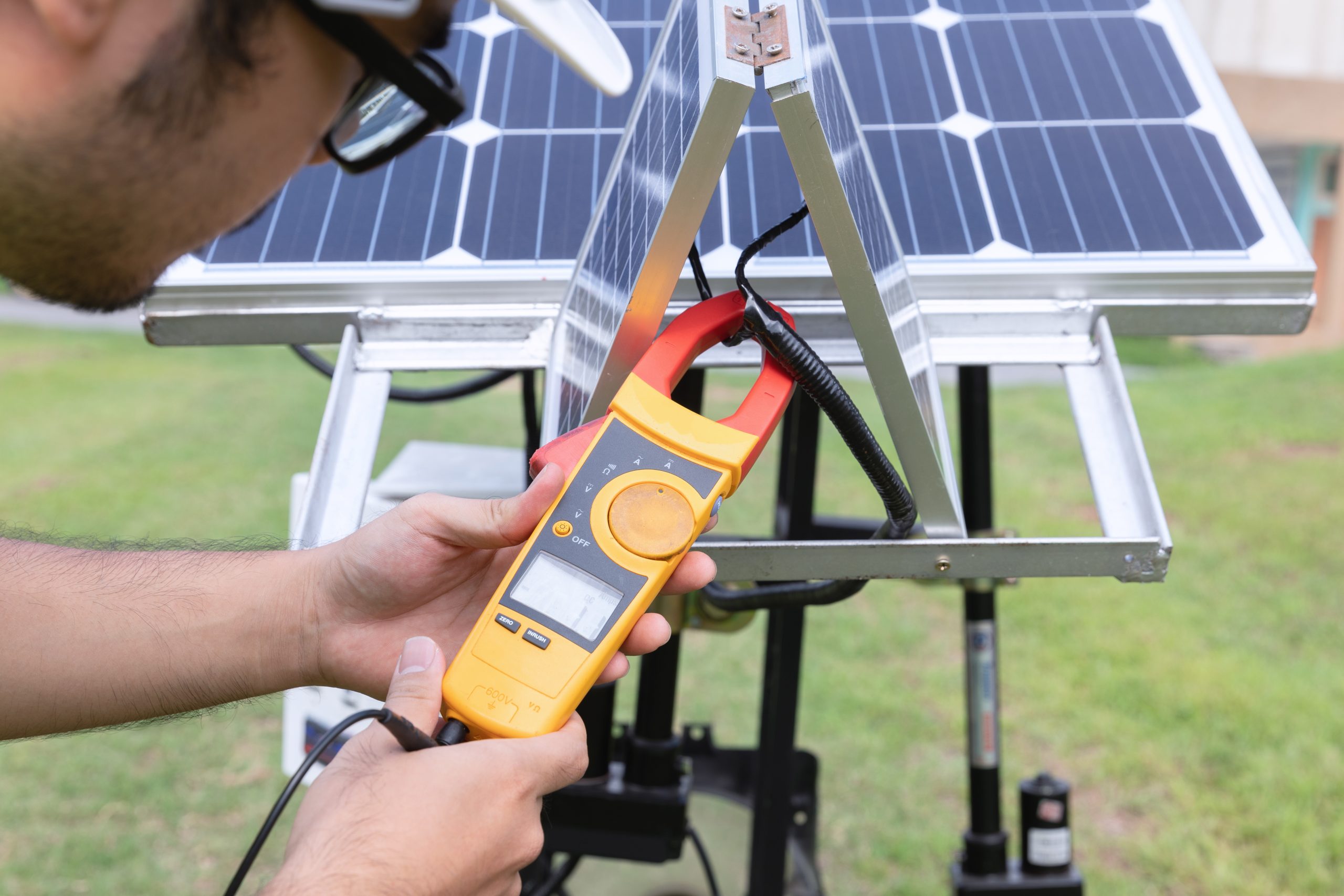 Engenheiro medindo painéis fotovoltaicos com equipamento