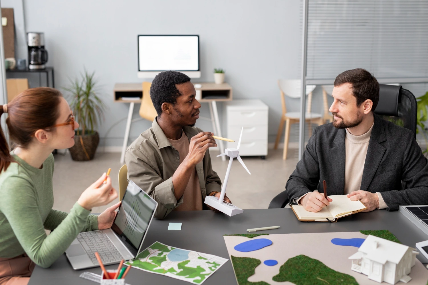 Imagem de profissionais discutindo e planejando estratégias relacionadas a uma carreira em ESG, focando em sustentabilidade e inovação.